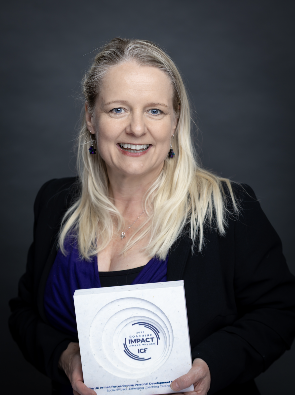 Tina proudly holding her 2025 ICF Impact Award